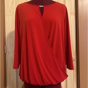 Red wrap top with gathered waistline and silver detail at neckline.